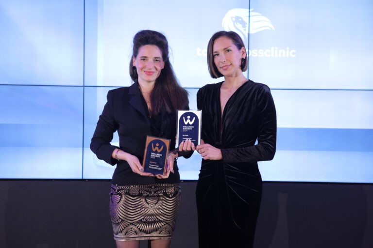 Peggy Stavrianou and Aspasia Fasoi holding two trophies at the Wellness Awards 2025