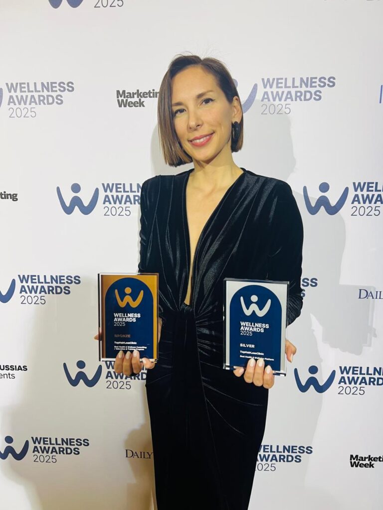 Peggy Stavrianou holding Best Health & Wellness Platform and Consulting awards