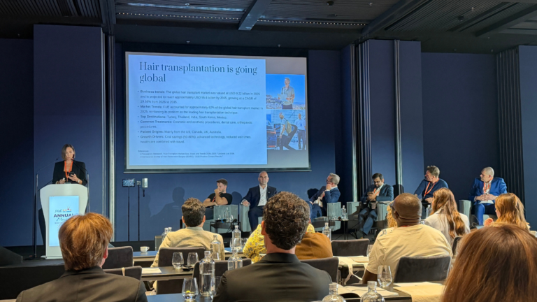 Peggy Stavrianou, CEO of TopHairLossClinic, speaking at FUE Europe 2026 in Warsaw